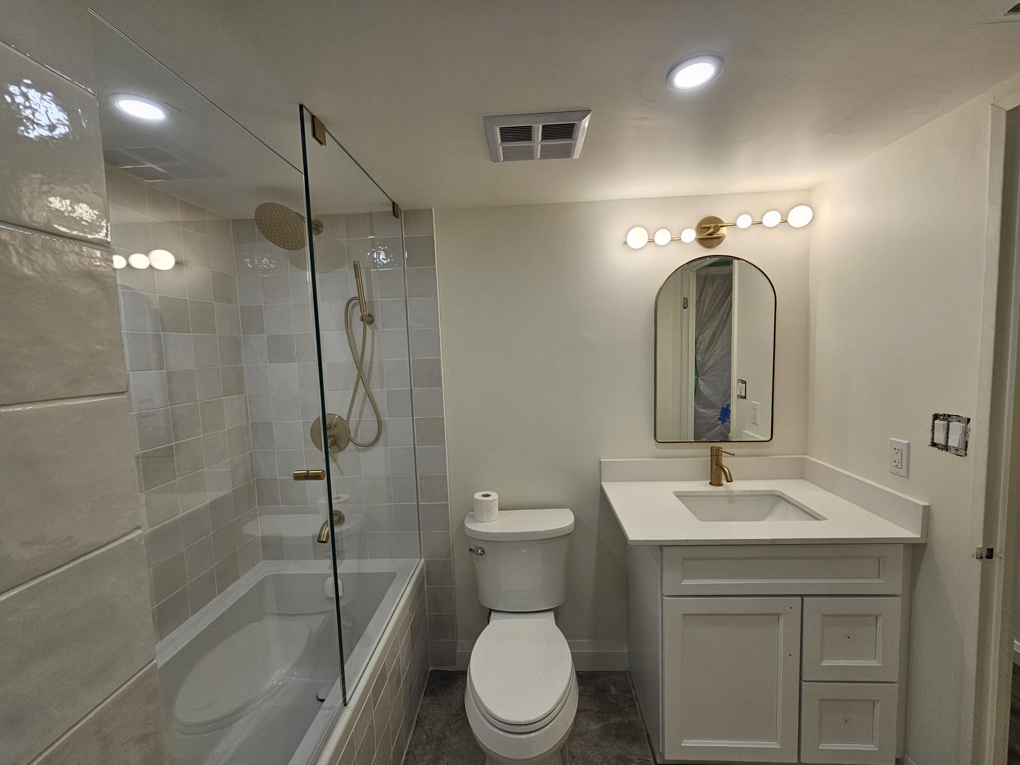 Modern white bathroom with glass shower and vanity
