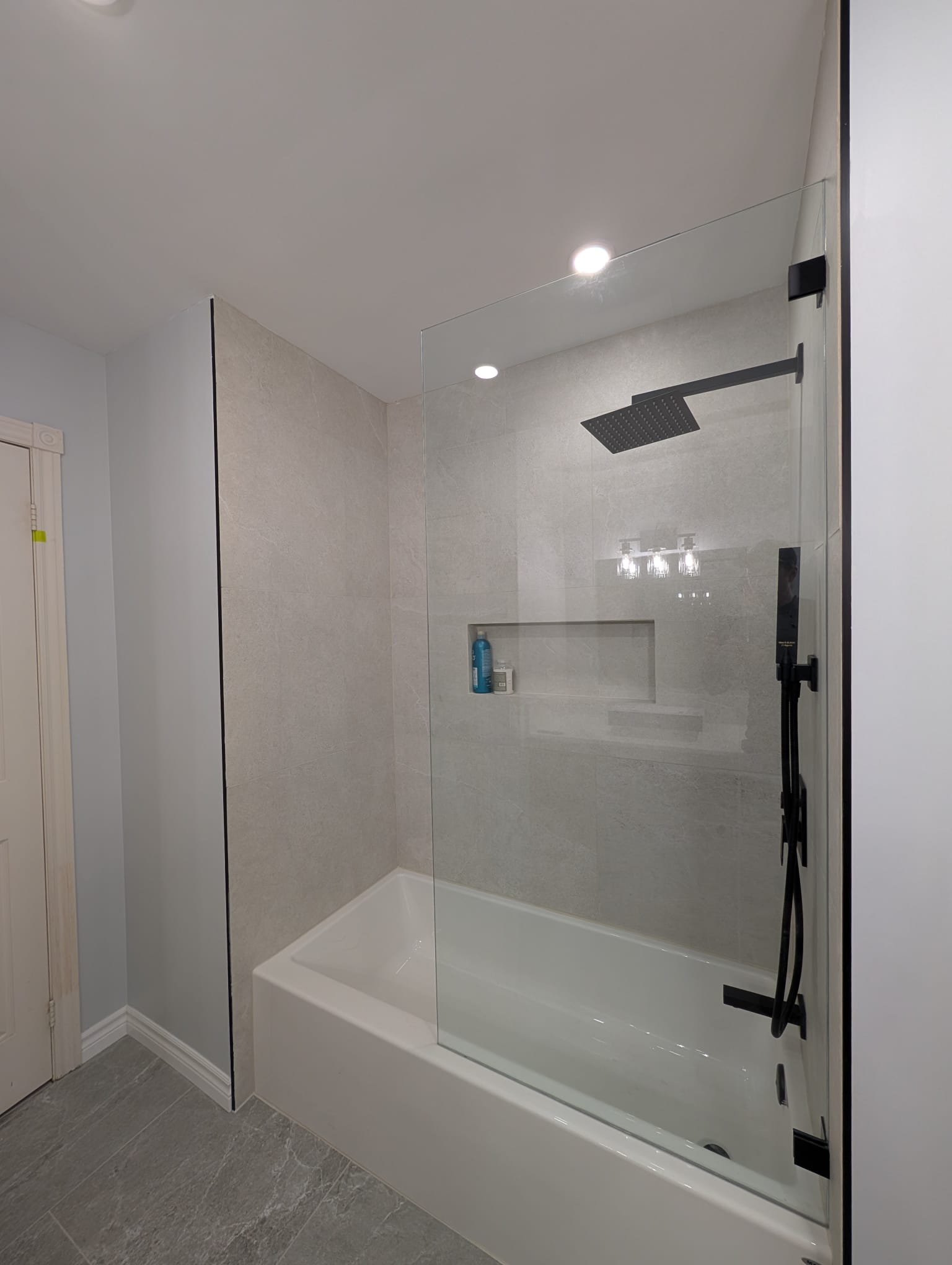 Modern bathtub shower with glass panel
