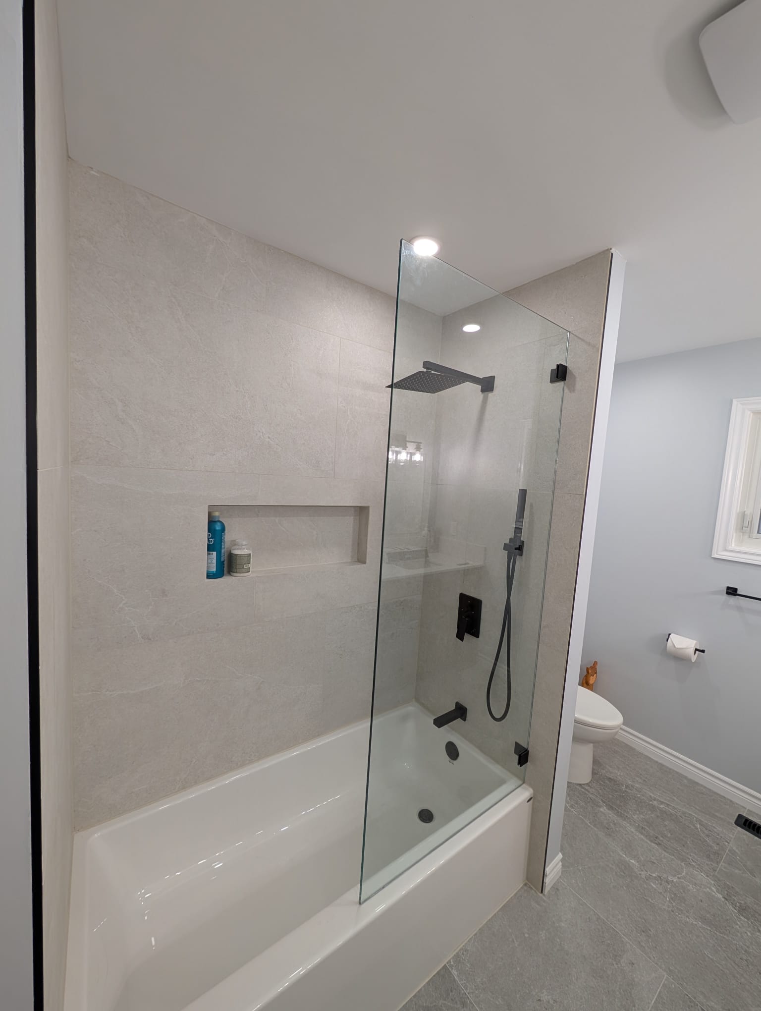 Modern bathroom with glass shower and bathtub