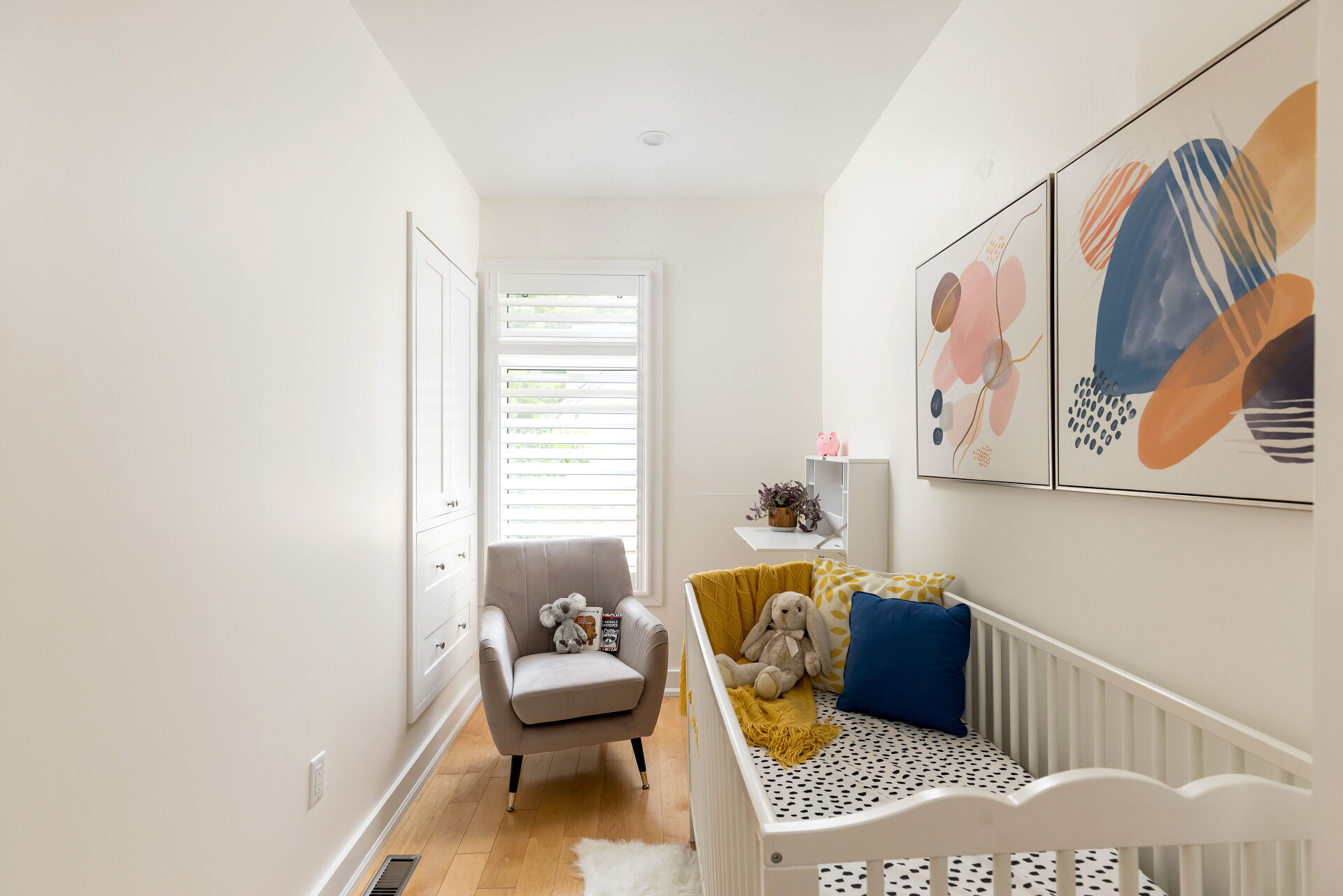 Modern nursery with crib and abstract wall art
