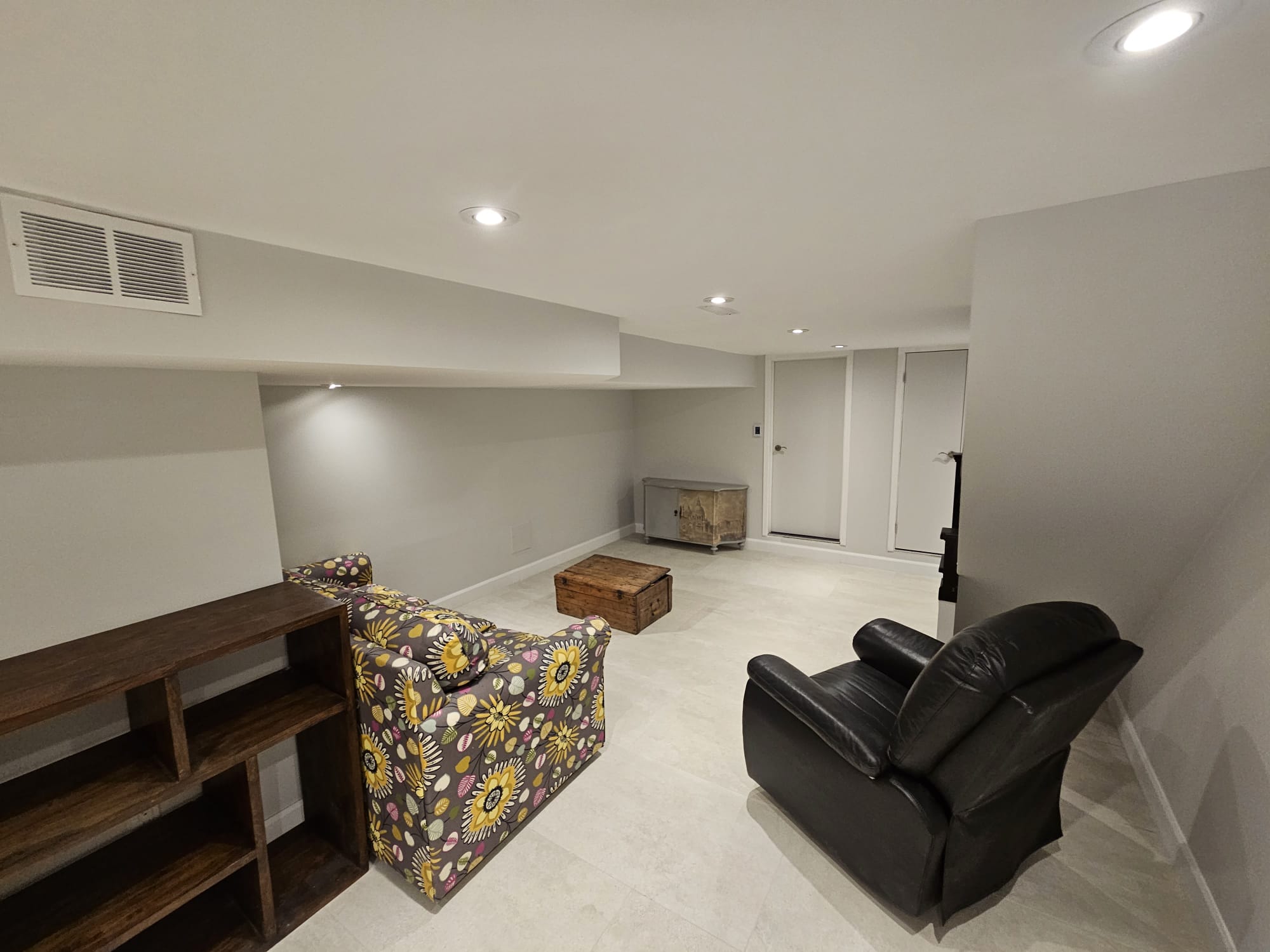 Finished basement living room with recliner and sofa