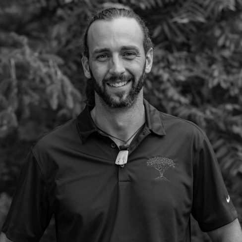 Smiling bearded man in polo shirt outdoors
