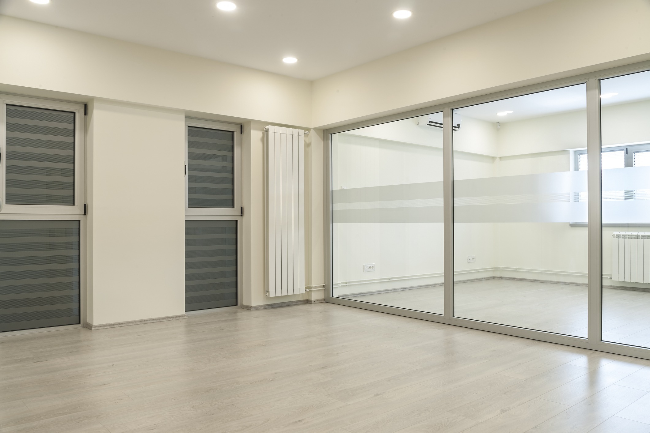 Empty modern room with glass partition and windows